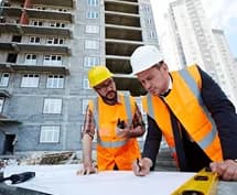 MZ Works tradespeople reviewing building plans on site