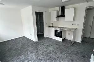 Refurbished room with new white kitchen units